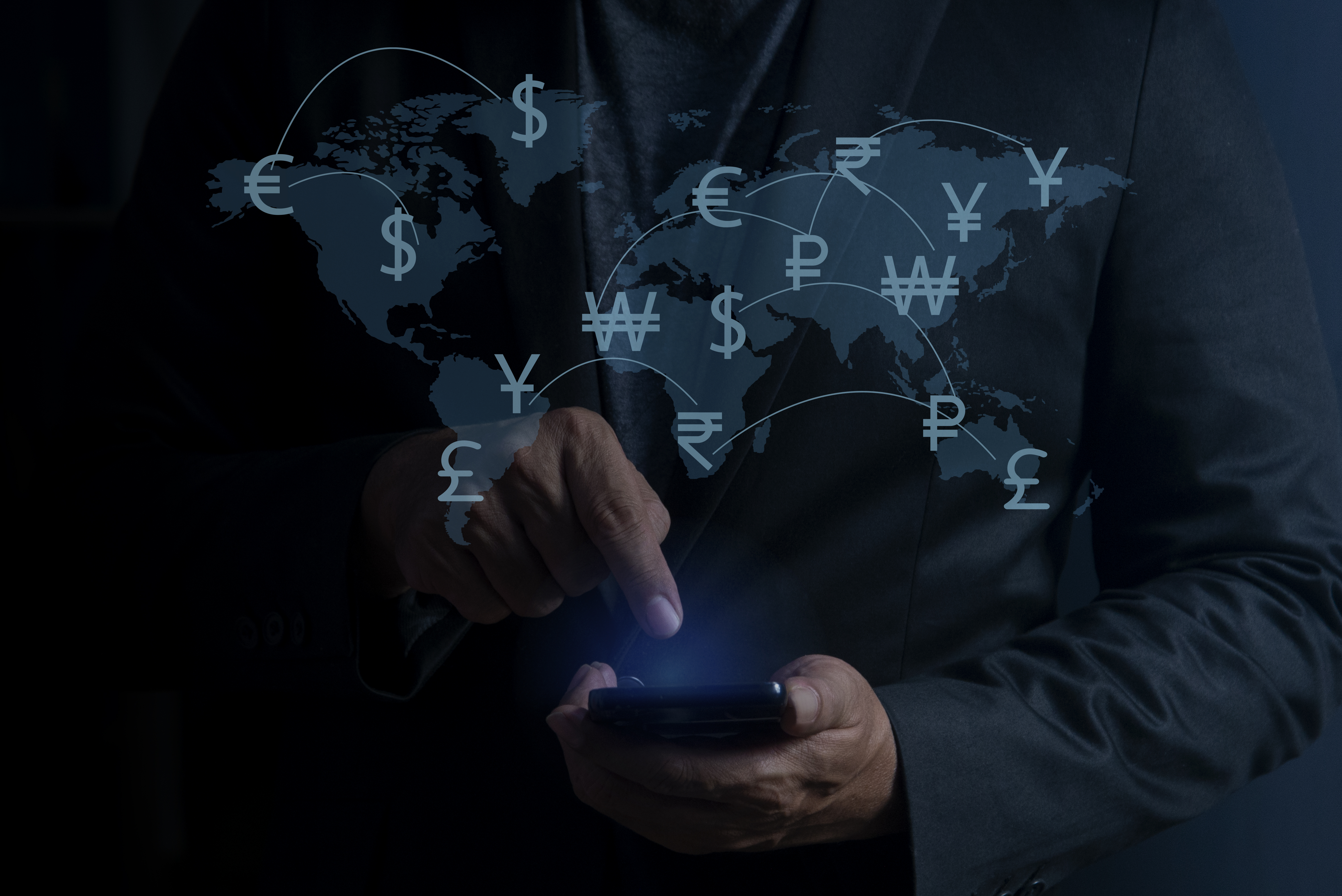Man using smartphone with online financial transactions for overseas spending. Financial and investment concept. money transfer and exchange, global currency concepts.